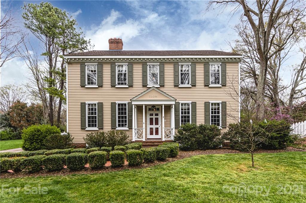 3229 Colony Road Charlotte, NC 28211 - Photo 1 of 44 a front view of a house with a garden and plants