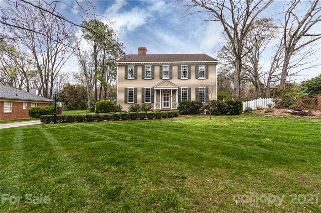 3229 Colony Road Charlotte, NC 28211 - Photo 2 of 44 a front view of a house with a garden and trees