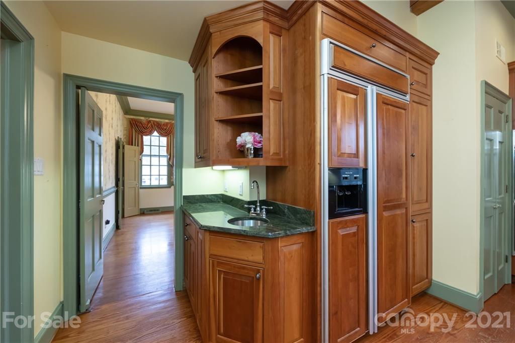 3229 Colony Road Charlotte, NC 28211 - Photo 11 of 44 a hallway with cabinets and wooden floor