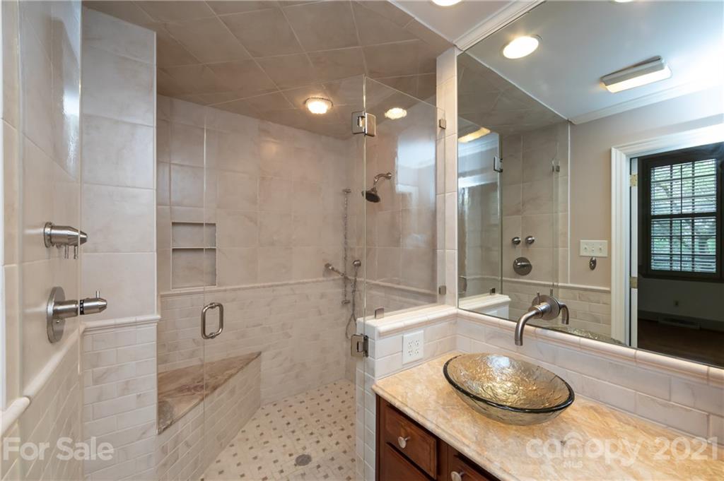 3229 Colony Road Charlotte, NC 28211 - Photo 18 of 44 a bathroom with a granite countertop sink a toilet and shower