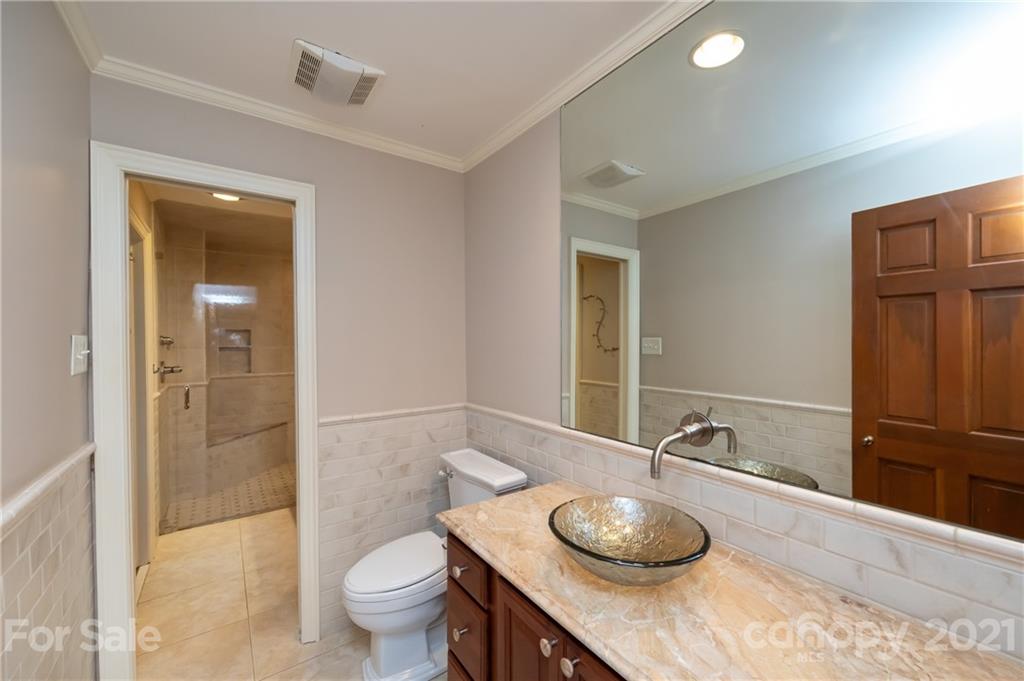 3229 Colony Road Charlotte, NC 28211 - Photo 20 of 44 a bathroom with a granite countertop sink and a mirror