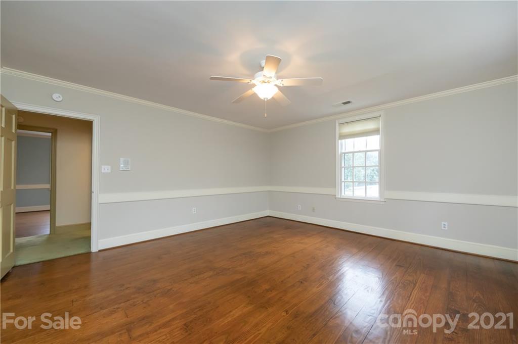 3229 Colony Road Charlotte, NC 28211 - Photo 25 of 44 wooden floor in an empty room with a window