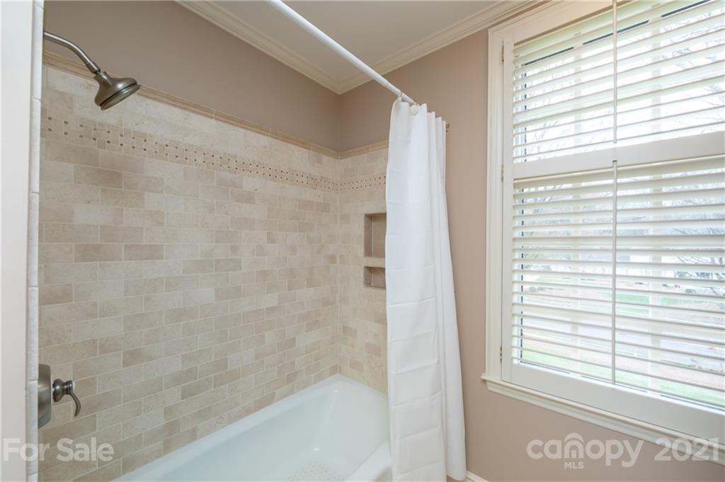 3229 Colony Road Charlotte, NC 28211 - Photo 28 of 44 a bathroom with a bathtub and a shower