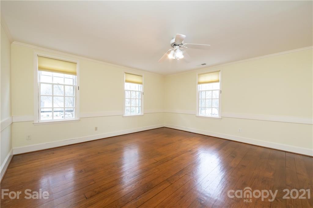 3229 Colony Road Charlotte, NC 28211 - Photo 29 of 44 an empty room with wooden floor and windows