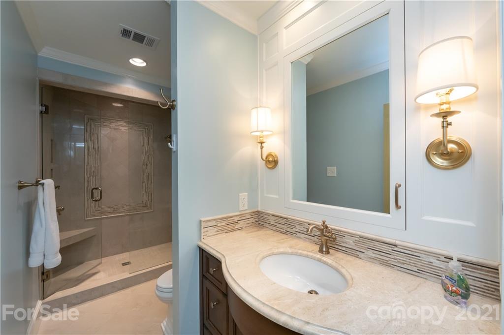 3229 Colony Road Charlotte, NC 28211 - Photo 31 of 44 a bathroom with a sink double vanity granite tub and shower