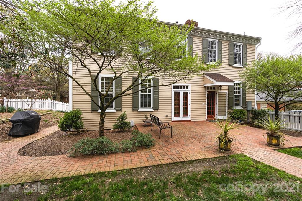 3229 Colony Road Charlotte, NC 28211 - Photo 41 of 44 a front view of a house with a yard and potted plants