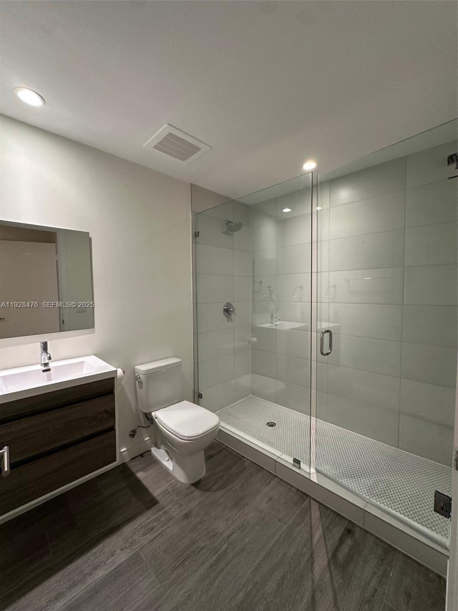 2900 Northeast 7th Avenue, Unit 1604 Miami, FL 33137 - Photo 8 of 10 a bathroom with a sink a toilet and shower