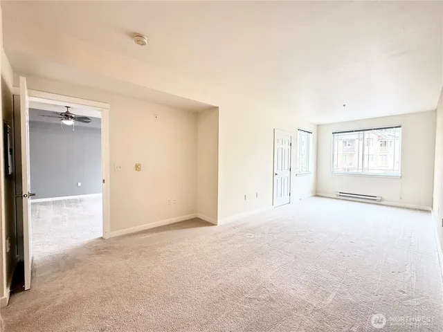 an empty room with windows and closet