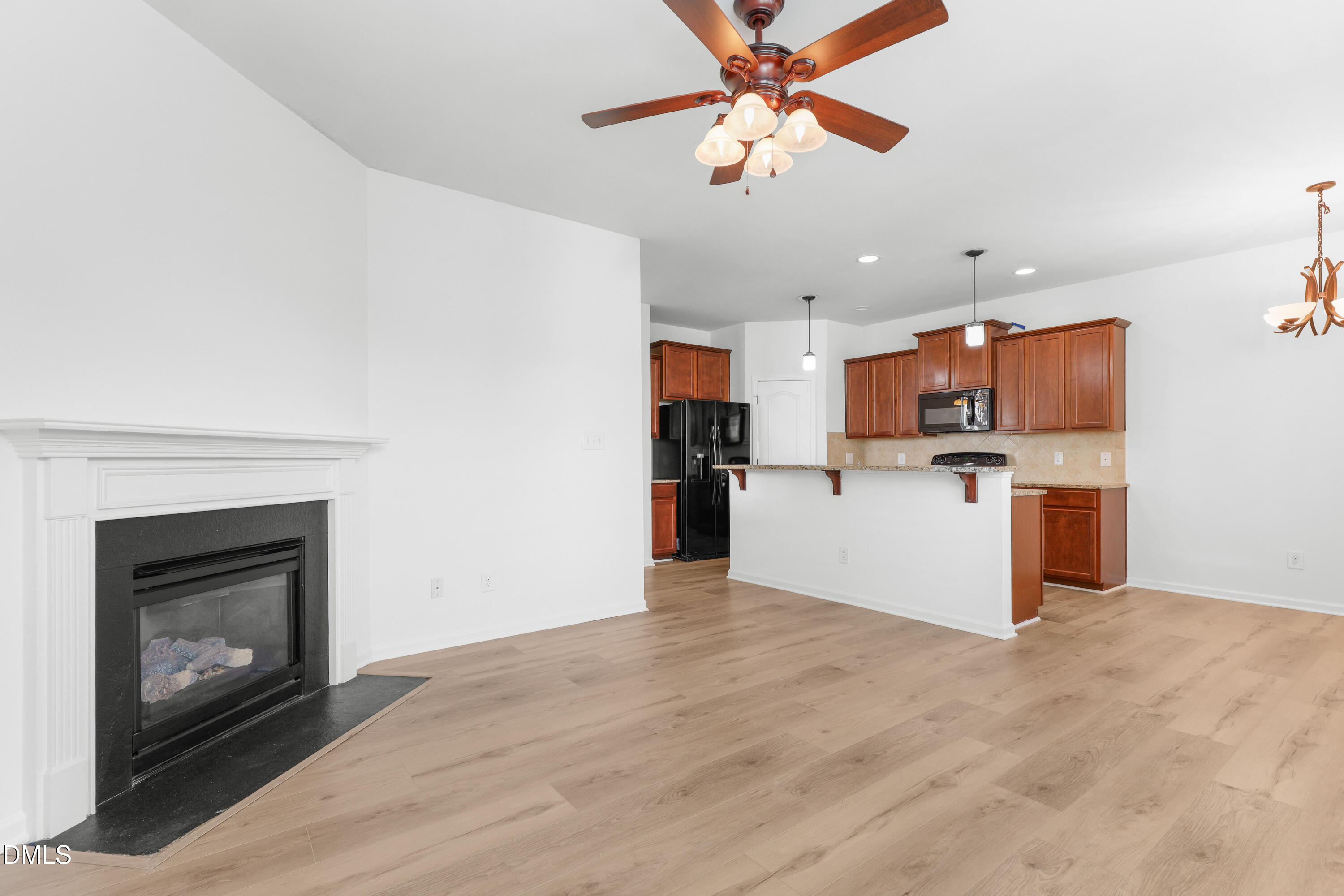 4400 Hillsgrove Road Wake Forest, NC 27587 - Photo 14 of 49 a view of a kitchen with a microwave and a ceiling fan