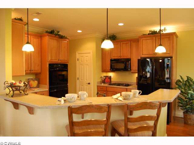 Kitchen - The Bridgewater MODEL Home is Now For Sale! Home Offers WATERVIEWS, WATERVIEWS, WATERVIEWS!!! Gorgeous Kitchenw/Wood Floors, Double Wall Ovens, Quartz Counter Tops, Breakfast Bar & So Much More.