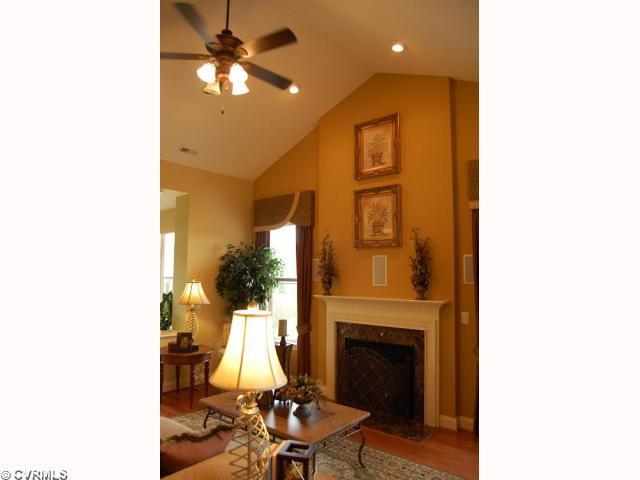 Living Room - Soaring Ceilings in the Living Room Creates a Dramatic Impact as you Enter into this Grand Room. Wood Floors, Gas Logs, Surround Sound, Built-in Speakers & More.