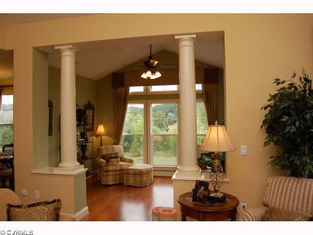 Other - Sunroom with Wood Floors & Columns Overlooking the Water.