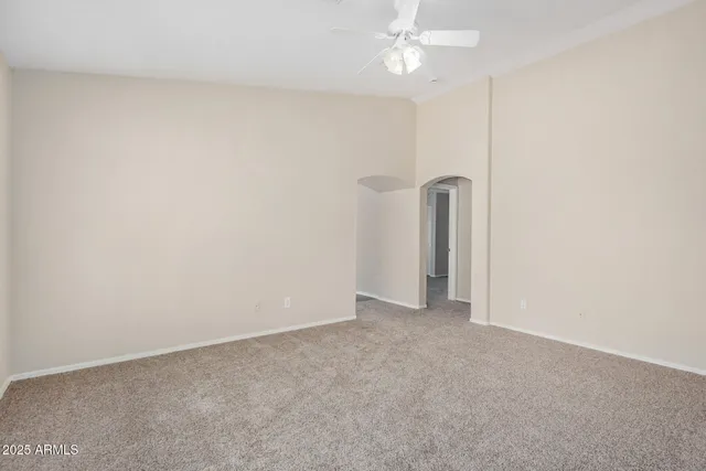 a view of a room with a ceiling fan and a window