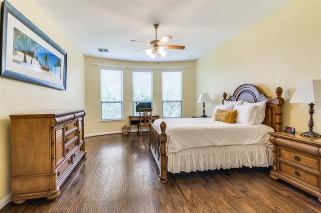 a bedroom with a bed and a large window