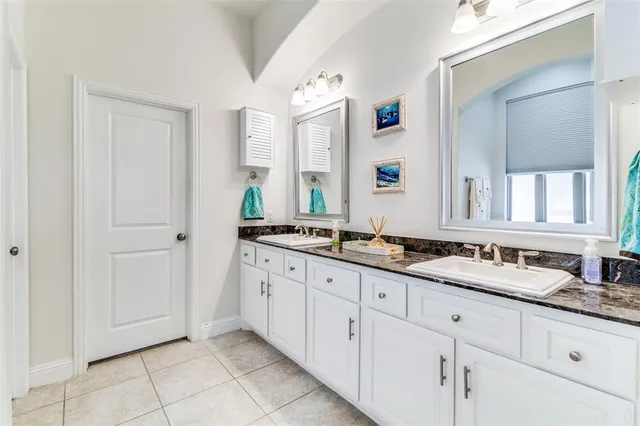 a bathroom with double sink and a mirror
