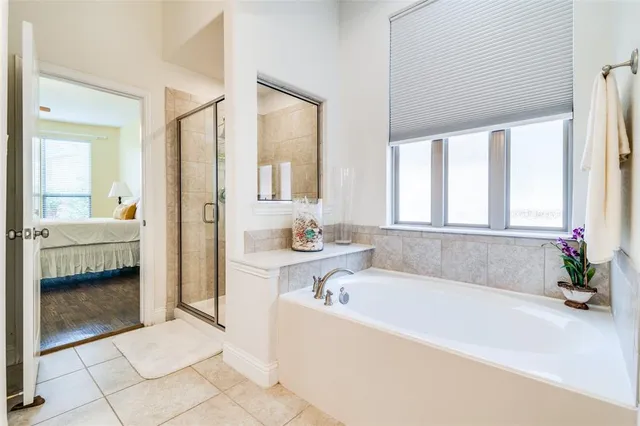 a bathroom with a tub a sink and a window