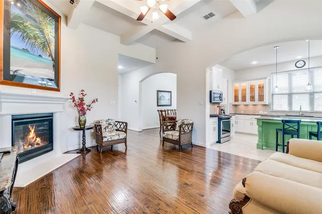 a living room with furniture fireplace and wooden floor