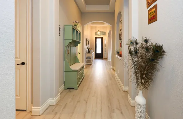 a view of a hallway with wooden floor and entryway