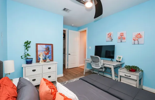 a bedroom with a bed and a flat screen tv