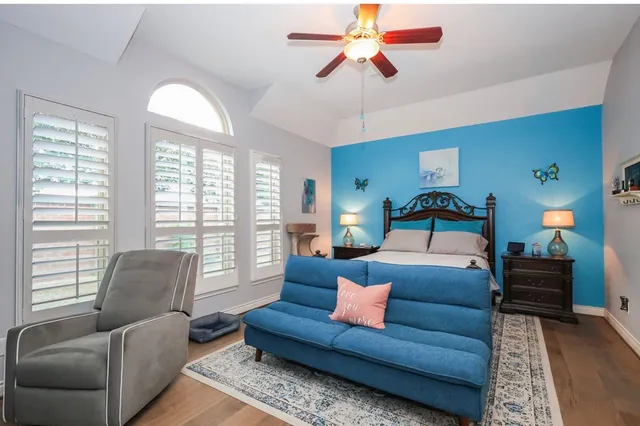 a bedroom with furniture and a large window