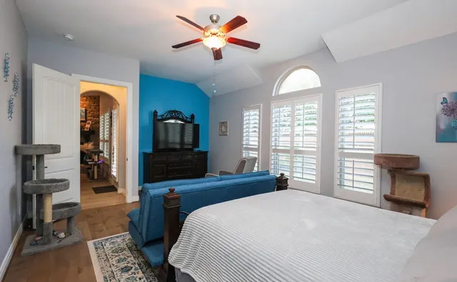 a bedroom with a bed and a chandelier