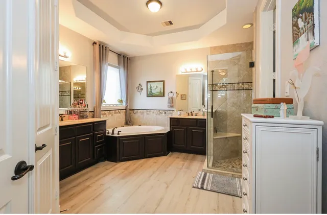 a large bathroom with a tub sink shower and mirror
