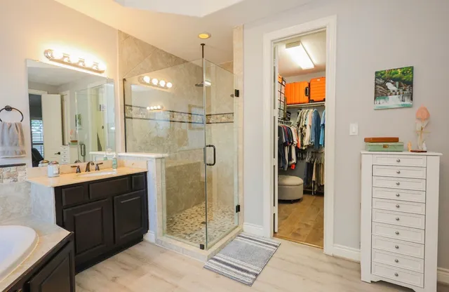 a bathroom with a double vanity sink mirror and shower