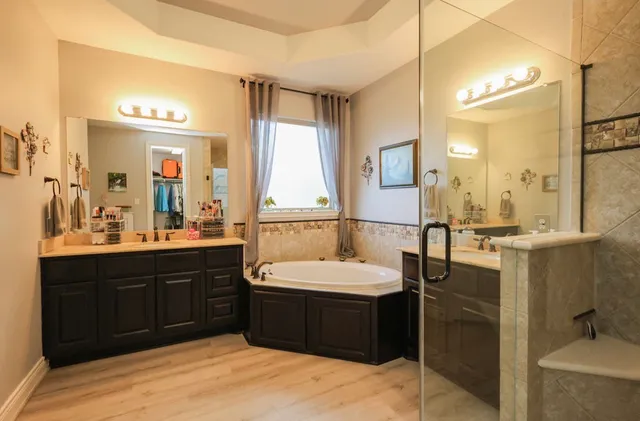 a bathroom with a sink double vanity and a mirror