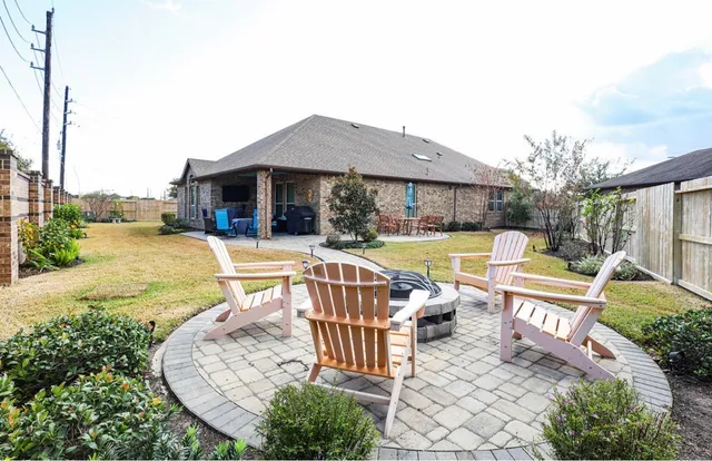 an outdoor sitting area with swimming pool and furniture