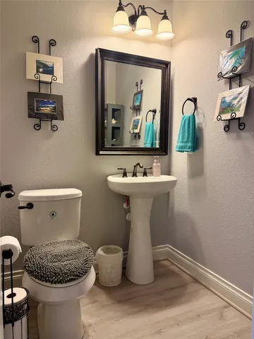 a bathroom with a sink toilet and mirror