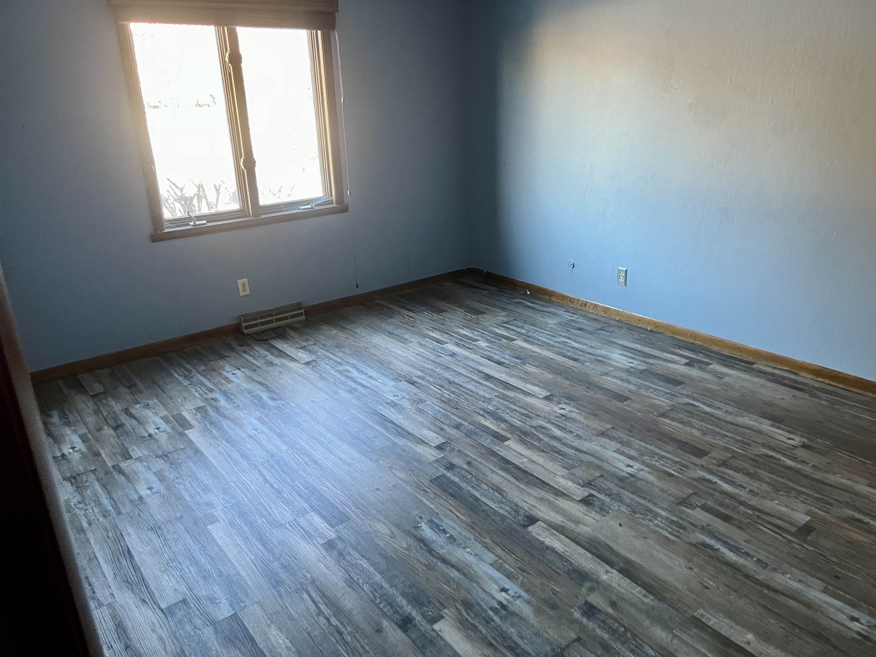 4575 Sunderman Road Rockford, IL 61114 - Photo 9 of 16 an empty room with wooden floor and windows