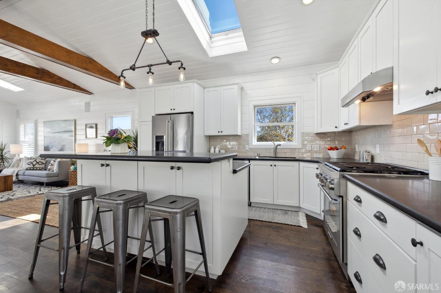 312 Kent Road Pacifica, CA 94044 - Photo 16 of 70 a kitchen with granite countertop white cabinets and stainless steel appliances