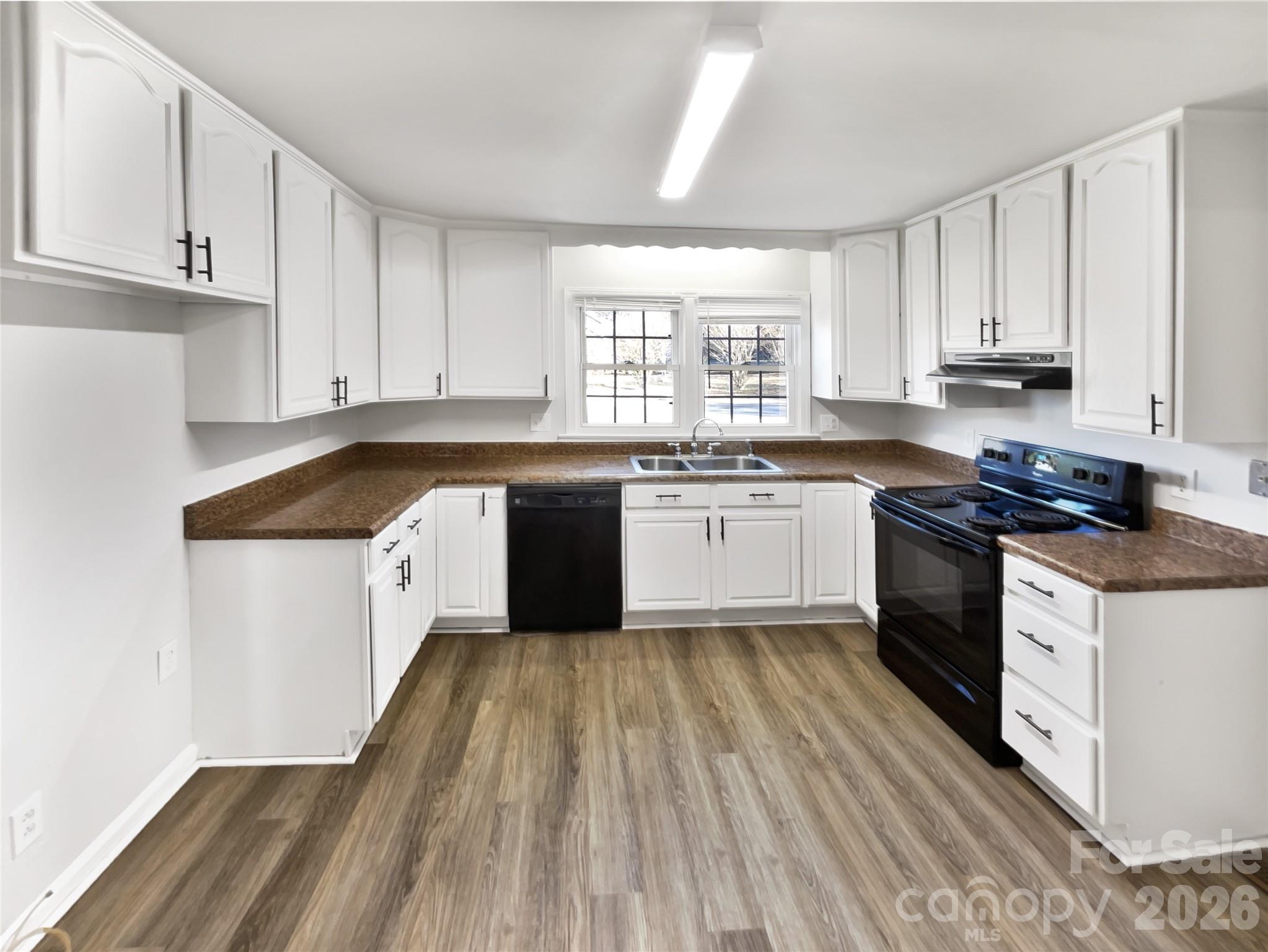 4748 Hickory Grove Road Mount Holly, NC 28120 - Photo 3 of 17 a kitchen with a sink a stove cabinets and a window