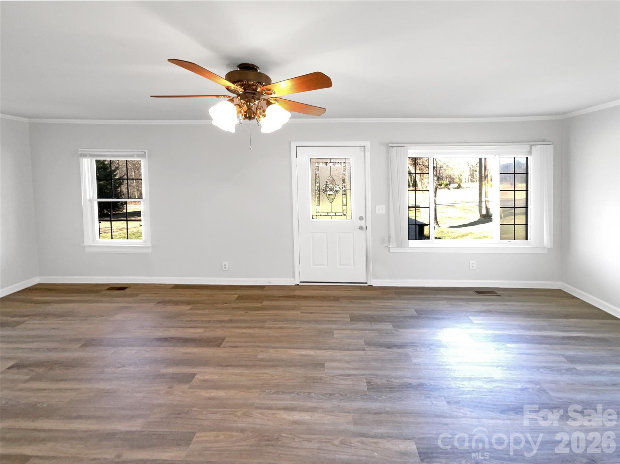 4748 Hickory Grove Road Mount Holly, NC 28120 - Photo 5 of 17 a view of an empty room with wooden floor and a window