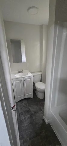 a bathroom with a toilet and a sink