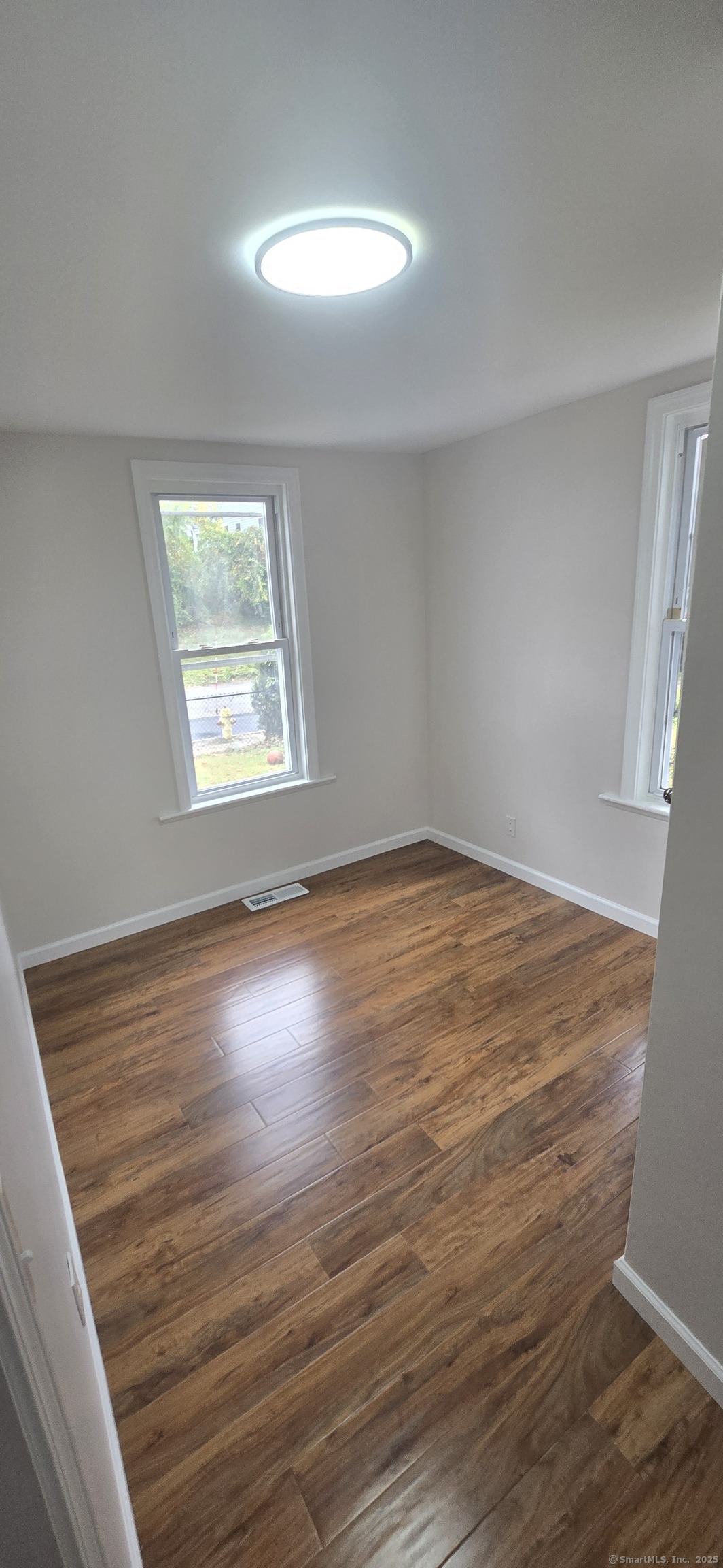 571 Wilson Street Waterbury, CT 06708 - Photo 8 of 23 wooden floor in an empty room with a window
