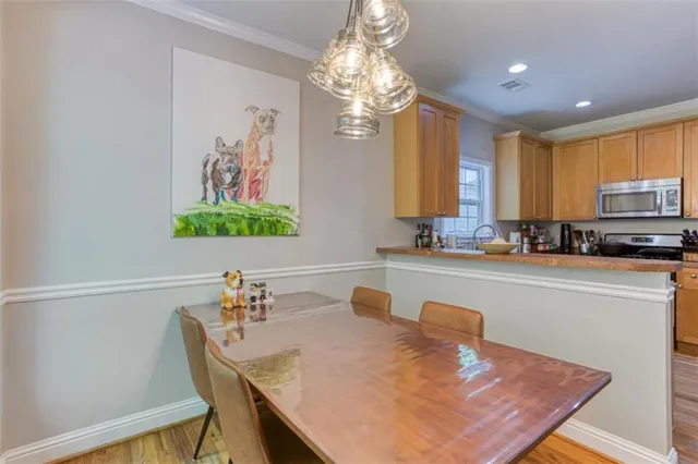 a kitchen with a table chairs sink and microwave