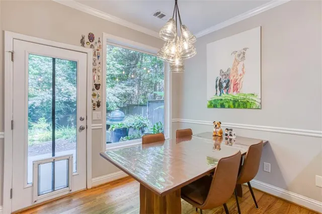 a dining room with furniture a livingroom view and wooden floor