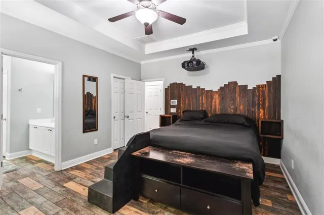 a bedroom with a bed and a chandelier