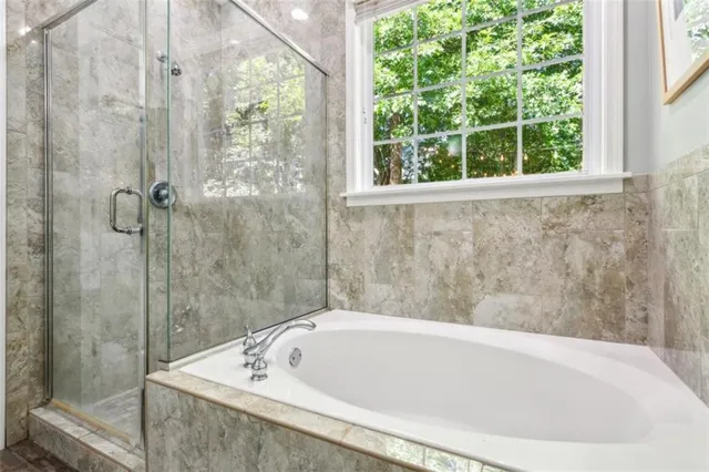 a bathroom with a tub and shower