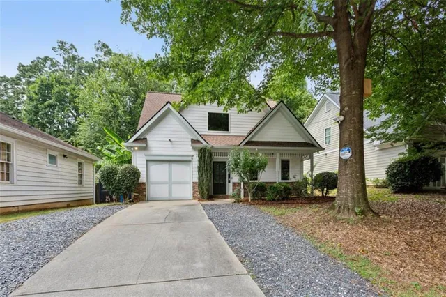 a front view of a house with yard and green space