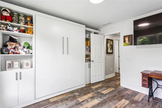 a view of room with furniture and wooden floor