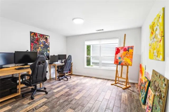 a view of a workspace with furniture and a window