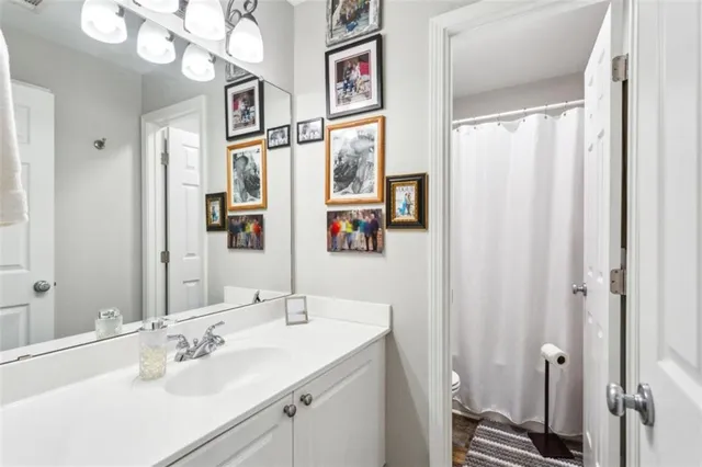 a bathroom with a sink vanity and a mirror