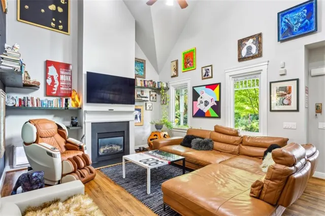 a living room with furniture a fireplace and a flat screen tv