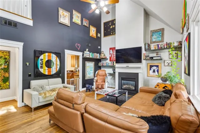 a living room with furniture a fireplace and a flat screen tv