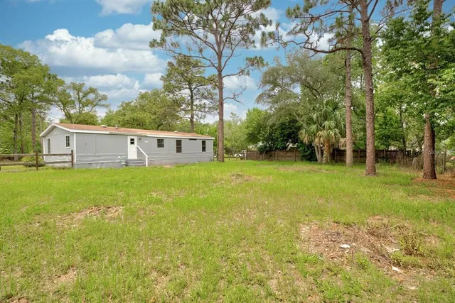 a view of a house with a big yard