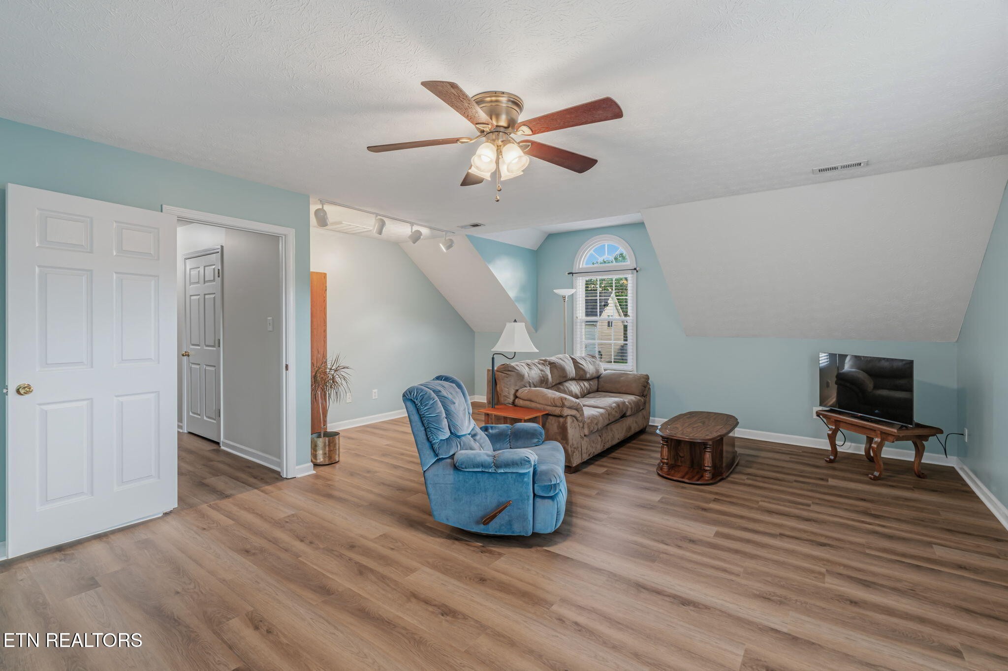 7030 Westerly Winds Road Knoxville, TN 37931 - Photo 32 of 40 a living room with furniture and a wooden floor