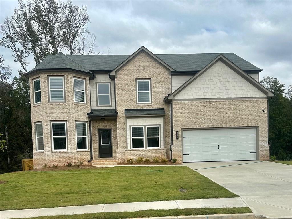 a front view of a house with a yard