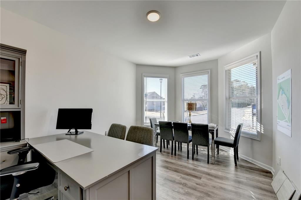 306 Rodeo Drive Auburn, GA 30011 - Photo 11 of 86 a view of a workspace with furniture and wooden floor